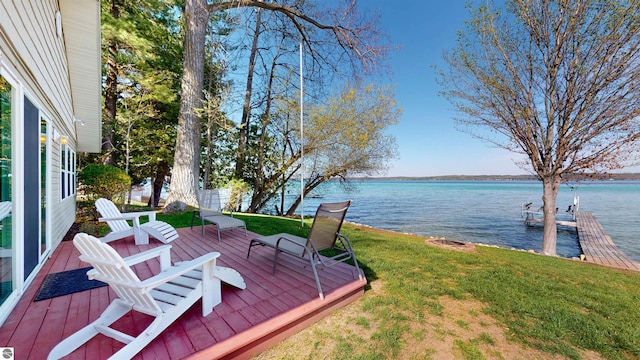 10701 SW Torch Lake Dr, Rapid City, MI 49676 - wooden terrace featuring a water view, a lawn, and a dock