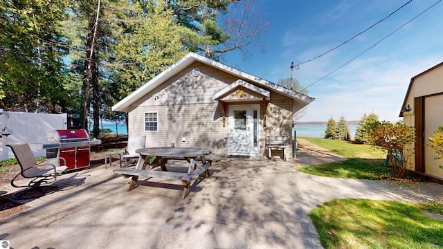 10701 SW Torch Lake Dr, Rapid City, MI 49676 - view of outbuilding with a water view and outdoor dining area