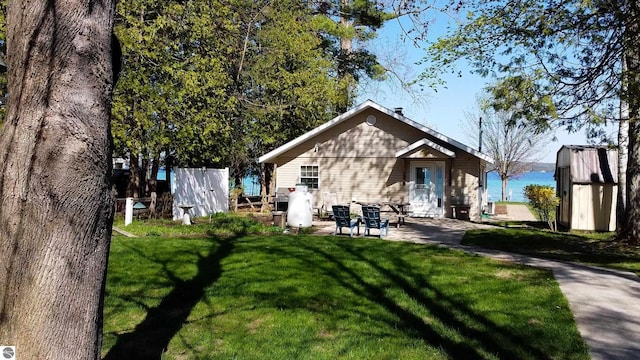 10701 SW Torch Lake Dr, Rapid City, MI 49676 - back of property with a yard