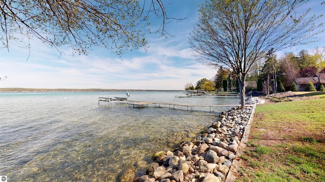10701 SW Torch Lake Dr, Rapid City, MI 49676 - dock featuring a water view