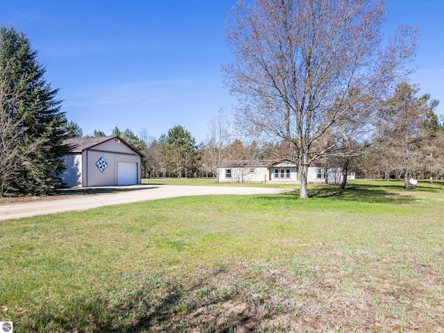 5891 N 19th Rd, Mesick, MI 49668 - view of green lawn with driveway, a garage, and an outdoor structure