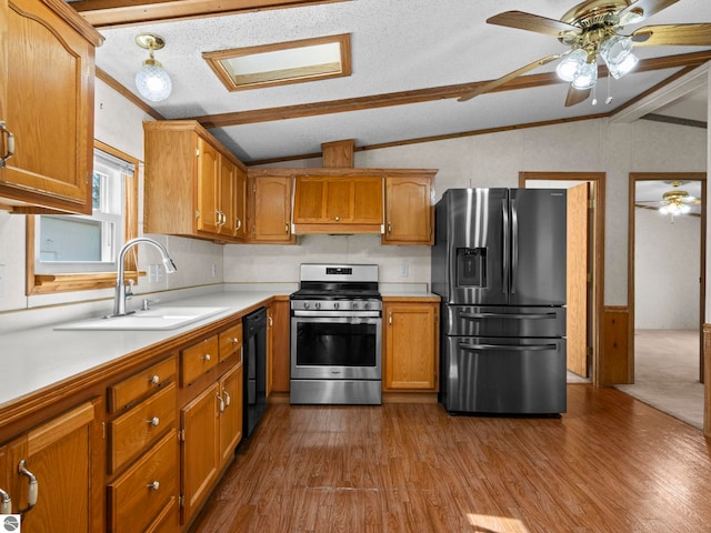 5891 N 19th Rd, Mesick, MI 49668 - kitchen with stainless steel appliances, vaulted ceiling, a sink, light countertops, and dark wood finished floors
