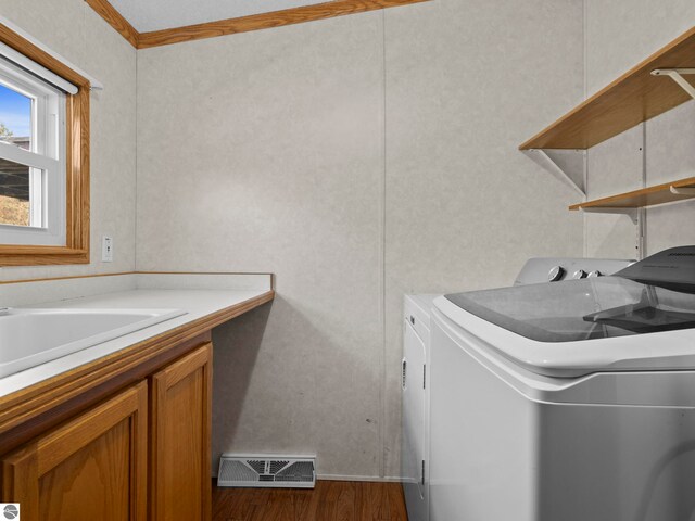 5891 N 19th Rd, Mesick, MI 49668 - clothes washing area with washing machine and dryer, dark wood-style floors, and cabinet space