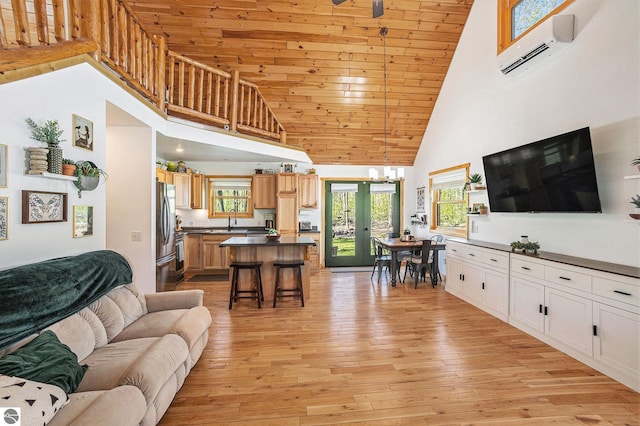 9266 Kenyon Trl, Frederic, MI 49733 - living area featuring high vaulted ceiling, light wood-style flooring, wooden ceiling, a chandelier, and a wall mounted air conditioner