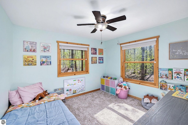 9266 Kenyon Trl, Frederic, MI 49733 - carpeted bedroom with baseboards and a ceiling fan