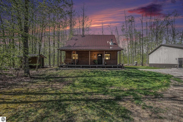 9266 Kenyon Trl, Frederic, MI 49733 - chalet / cabin featuring a porch, a front lawn, metal roof, an outbuilding, and log veneer siding