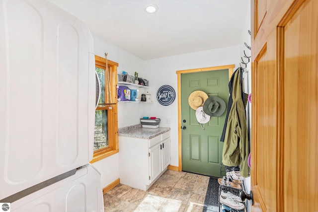 9266 Kenyon Trl, Frederic, MI 49733 - entryway featuring baseboards and light stone finish floors