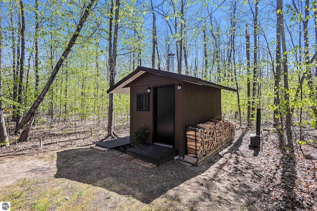 9266 Kenyon Trl, Frederic, MI 49733 - view of shed with a wooded view