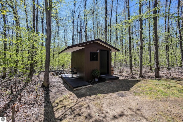 9266 Kenyon Trl, Frederic, MI 49733 - view of shed featuring a forest view
