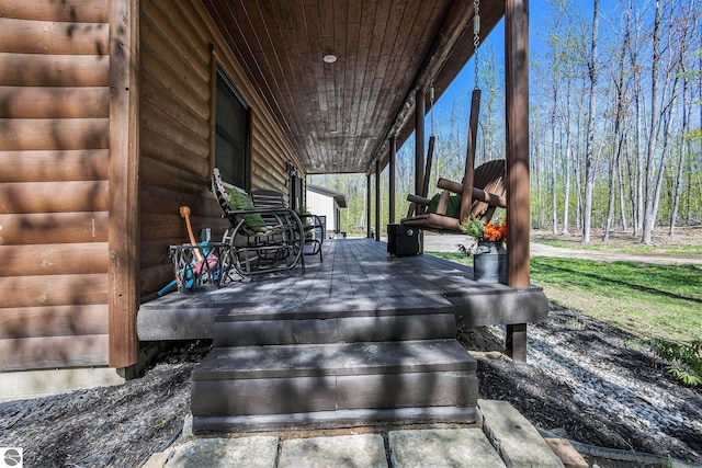 9266 Kenyon Trl, Frederic, MI 49733 - wooden deck with covered porch