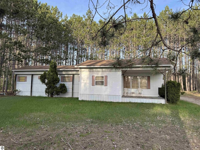 2737 County Road 633, Grawn, MI 49637 - view of front facade featuring a front lawn and covered porch