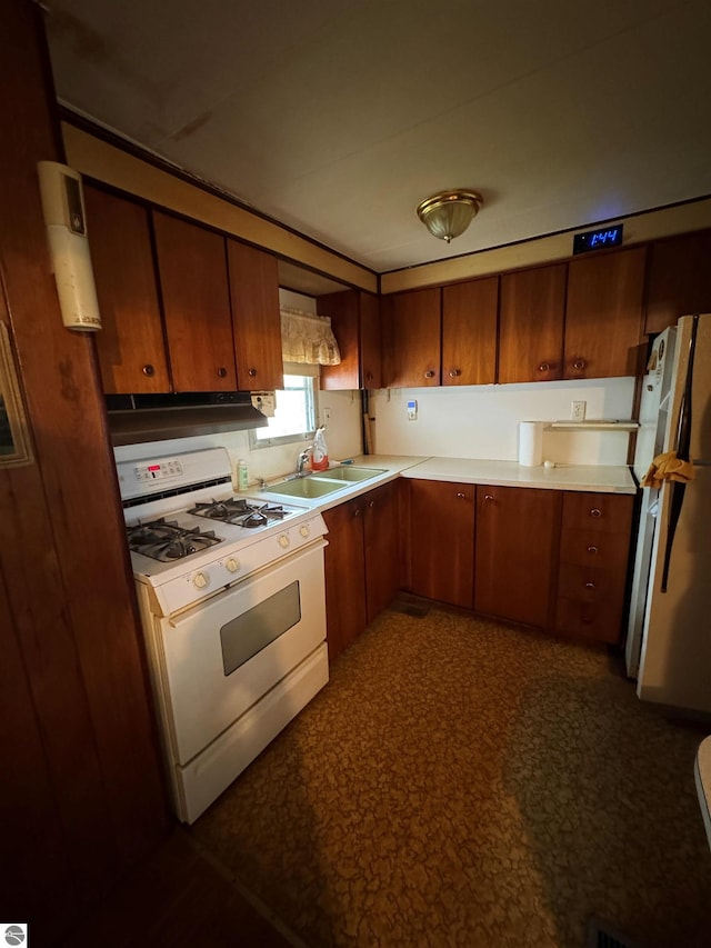 2737 County Road 633, Grawn, MI 49637 - kitchen with gas range, a sink, freestanding refrigerator, and light countertops