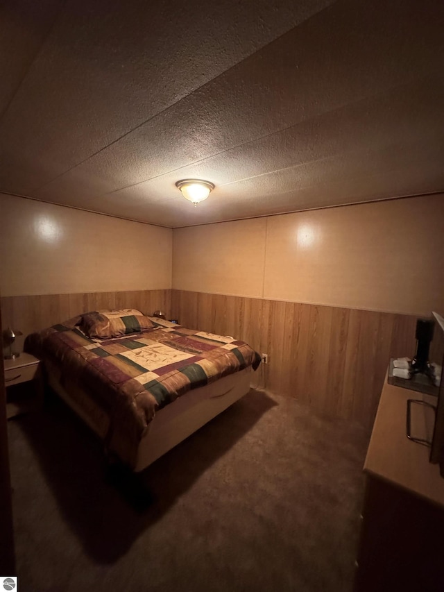2737 County Road 633, Grawn, MI 49637 - carpeted bedroom featuring wainscoting and wood walls