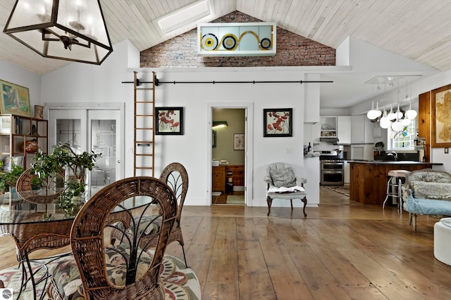 203 W 2nd St, Elk Rapids, MI 49629 - dining area featuring a skylight, wood-type flooring, high vaulted ceiling, and wooden ceiling