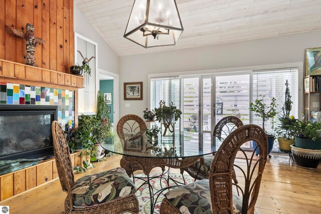 203 W 2nd St, Elk Rapids, MI 49629 - dining area featuring wood-type flooring, lofted ceiling, a fireplace, and wooden ceiling