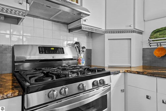 203 W 2nd St, Elk Rapids, MI 49629 - kitchen featuring stainless steel range with gas stovetop, under cabinet range hood, tasteful backsplash, and dark countertops