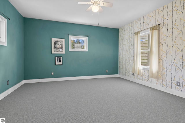203 W 2nd St, Elk Rapids, MI 49629 - carpeted spare room featuring healthy amount of natural light, wallpapered walls, a ceiling fan, and baseboards