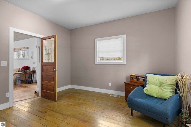 203 W 2nd St, Elk Rapids, MI 49629 - living area with light wood-style floors, baseboards, and healthy amount of natural light