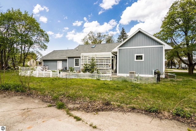 203 W 2nd St, Elk Rapids, MI 49629 - back of house featuring roof with shingles and board and batten siding
