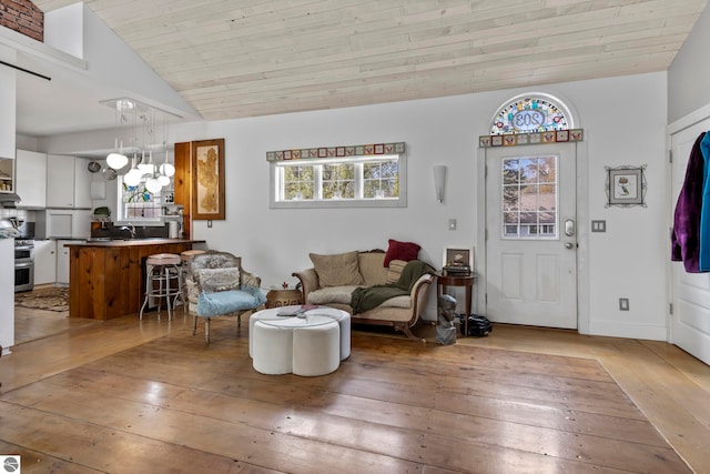 203 W 2nd St, Elk Rapids, MI 49629 - living room featuring wood-type flooring, a chandelier, wood ceiling, and vaulted ceiling