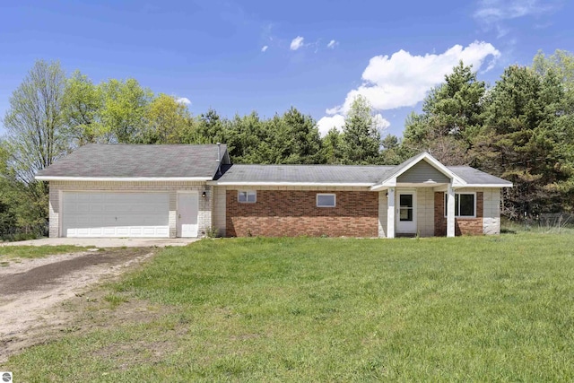 single story home with an attached garage, driveway, a front lawn, and brick siding