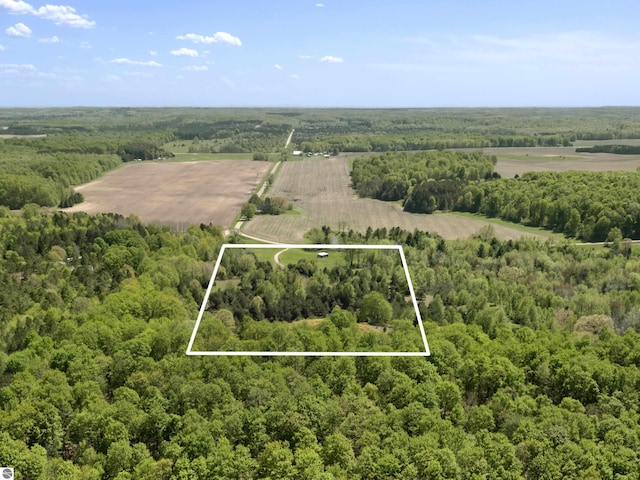 overview of rural landscape featuring a heavily wooded area and property boundaries highlighted