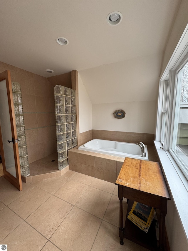 bathroom with a garden tub, a tile shower, tile patterned floors, and recessed lighting