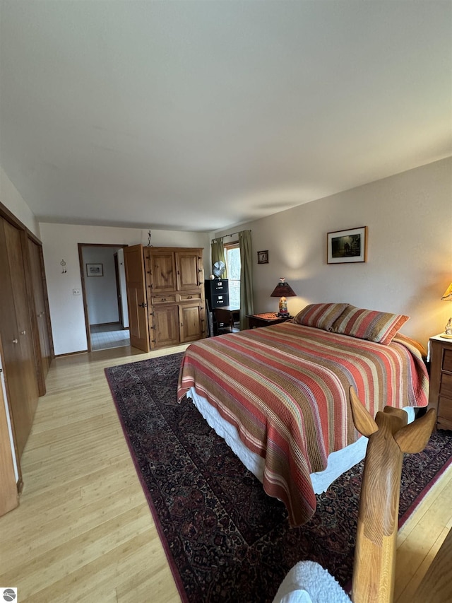 bedroom featuring light wood-style flooring and baseboards