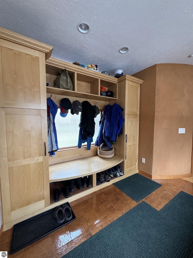 mudroom featuring baseboards and a textured ceiling