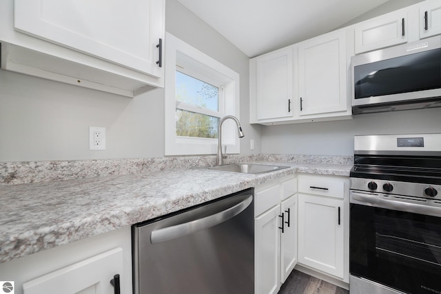 3218 S 41st Rd, Cadillac, MI 49601 - kitchen featuring appliances with stainless steel finishes, a sink, light countertops, and white cabinetry