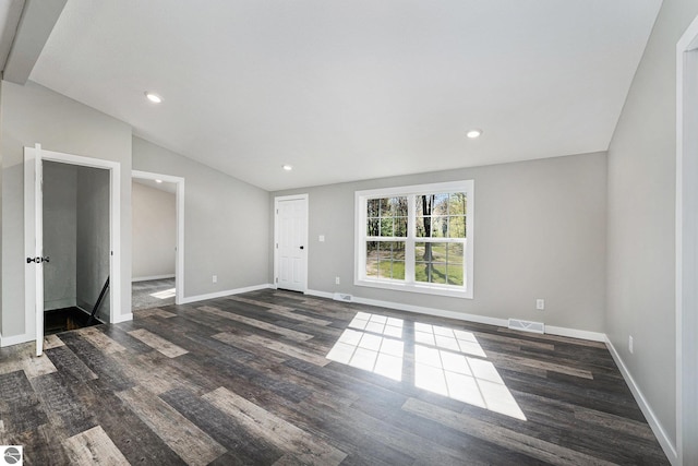 3218 S 41st Rd, Cadillac, MI 49601 - unfurnished living room featuring wood finished floors, lofted ceiling, baseboards, and recessed lighting