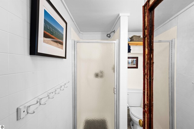 429 S Shabwasung St, Northport, MI 49670 - full bath featuring a shower stall, toilet, and tile walls