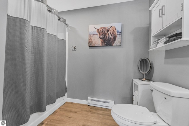 full bathroom featuring a baseboard radiator, toilet, wood finished floors, a shower with curtain, and baseboards