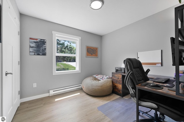 office space featuring a baseboard radiator, light wood finished floors, and baseboards