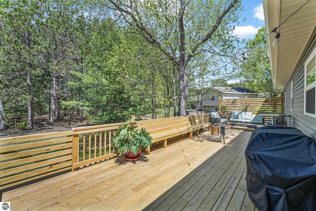 deck featuring area for grilling and an outdoor hangout area
