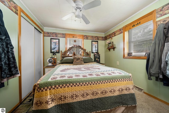 6202 Fletcher Rd, Fife Lake, MI 49633 - carpeted bedroom featuring baseboards, crown molding, a closet, and ceiling fan