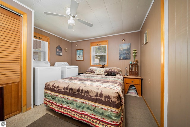 6202 Fletcher Rd, Fife Lake, MI 49633 - carpeted bedroom with washing machine and dryer, crown molding, ceiling fan, and wooden walls