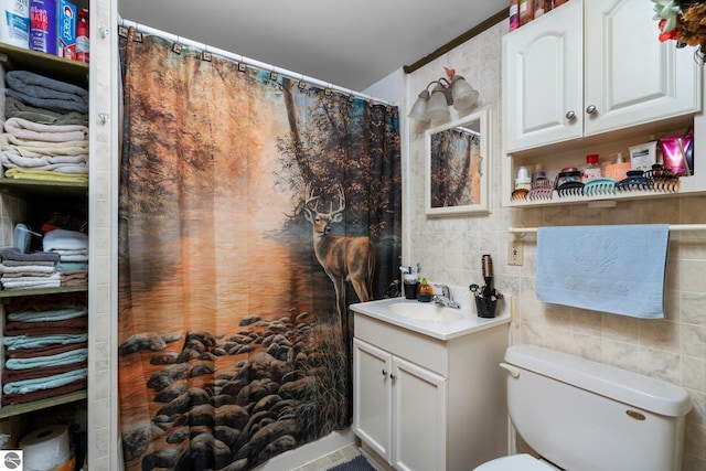 6202 Fletcher Rd, Fife Lake, MI 49633 - bathroom featuring tile walls, vanity, toilet, tasteful backsplash, and a shower with shower curtain