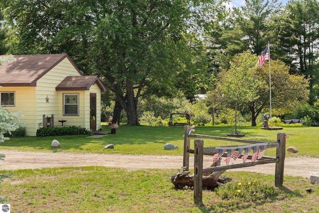 6202 Fletcher Rd, Fife Lake, MI 49633 - view of green lawn with view of wooded area