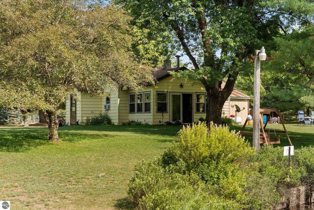 6202 Fletcher Rd, Fife Lake, MI 49633 - rear view of property featuring a lawn