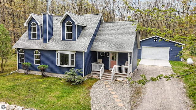 4480 Mockingbird Cir, Farwell, MI 48622 - view of front facade with covered porch, a shingled roof, a detached garage, and a front lawn