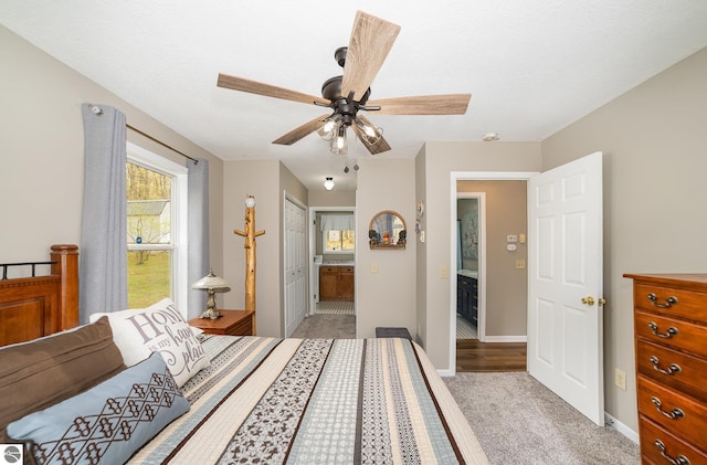 4480 Mockingbird Cir, Farwell, MI 48622 - bedroom featuring baseboards, light colored carpet, a ceiling fan, and connected bathroom