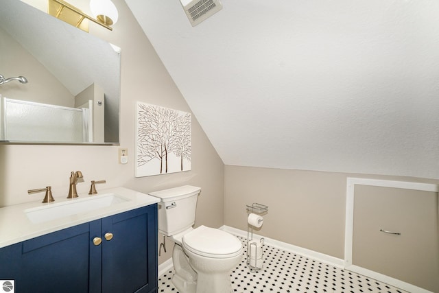 4480 Mockingbird Cir, Farwell, MI 48622 - full bathroom with vaulted ceiling, toilet, an enclosed shower, vanity, and baseboards