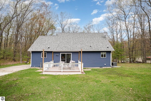 4480 Mockingbird Cir, Farwell, MI 48622 - rear view of house with roof with shingles, a lawn, and a wooden deck
