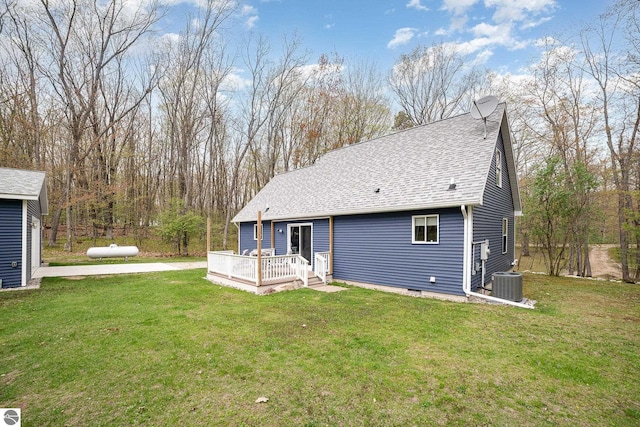 4480 Mockingbird Cir, Farwell, MI 48622 - rear view of property with a deck, cooling unit, roof with shingles, and a yard