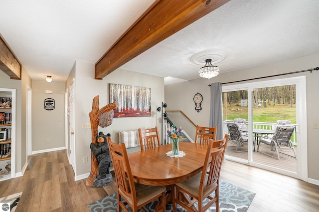 4480 Mockingbird Cir, Farwell, MI 48622 - dining space with light wood-style floors, beam ceiling, baseboards, and a chandelier