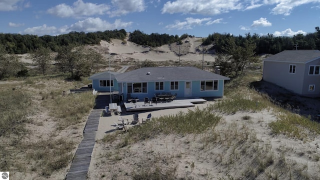 14463 Cathead Bay Dr, Northport, MI 49670 - rear view of house featuring a deck with mountain view and a chimney