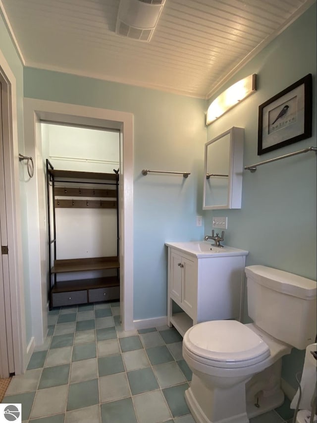 14463 Cathead Bay Dr, Northport, MI 49670 - bathroom with toilet, vanity, tile patterned floors, and baseboards