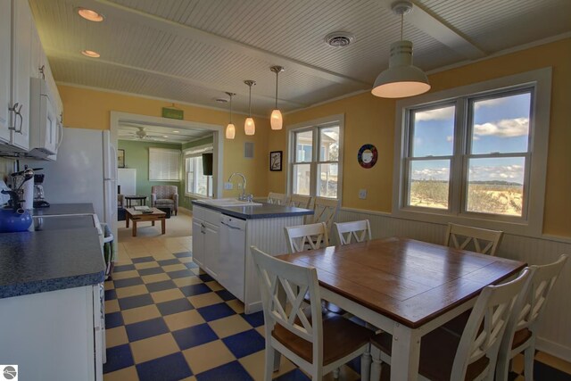14463 Cathead Bay Dr, Northport, MI 49670 - dining room with light flooring, wainscoting, a ceiling fan, and recessed lighting