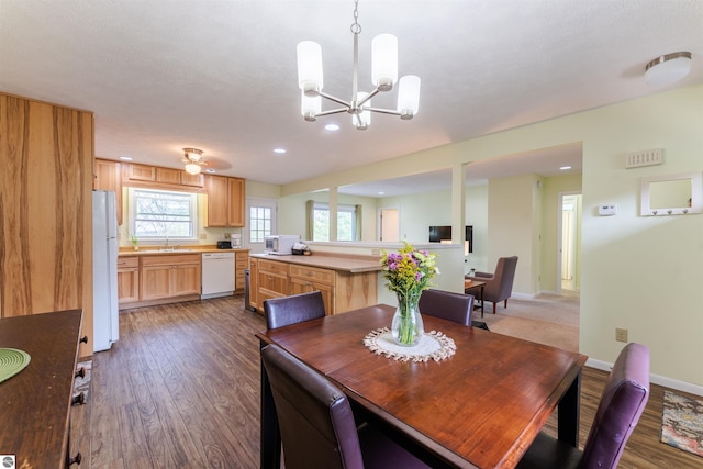 4237 Hearthside Dr, Traverse City, MI 49684 - dining room with dark wood-style floors, a chandelier, recessed lighting, and baseboards